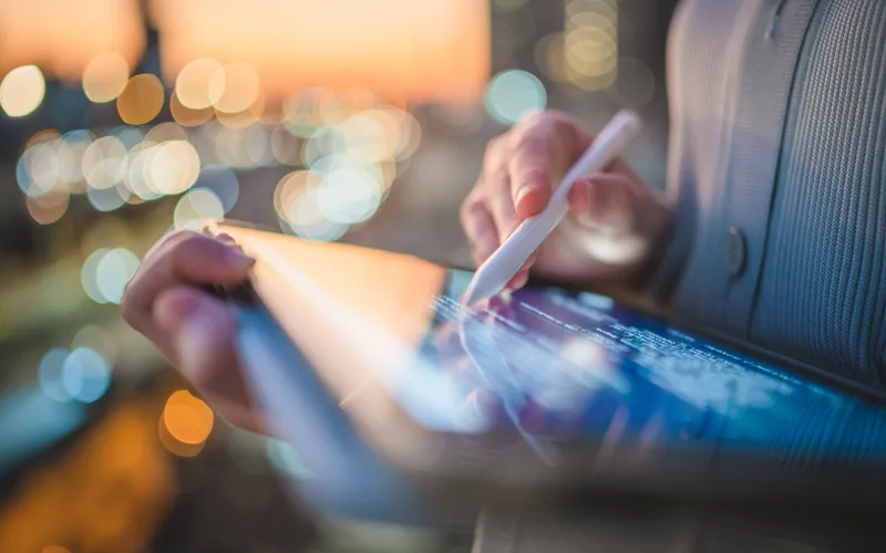 image of a woman using a tablet and digital stylus